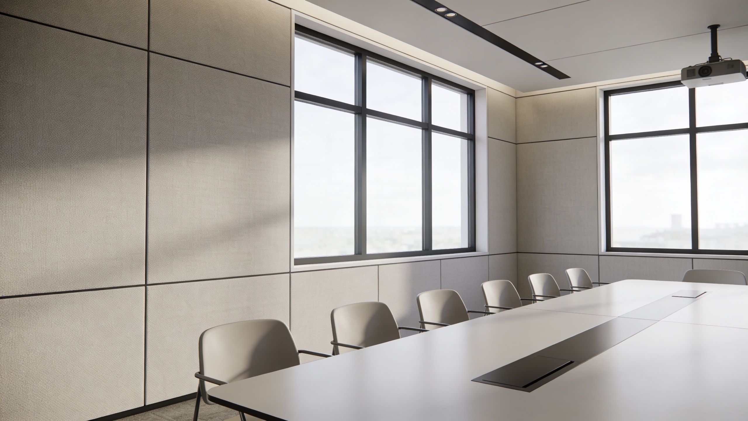 A modern, minimalist boardroom featuring a long table, ergonomic chairs, and large windows with natural lighting.